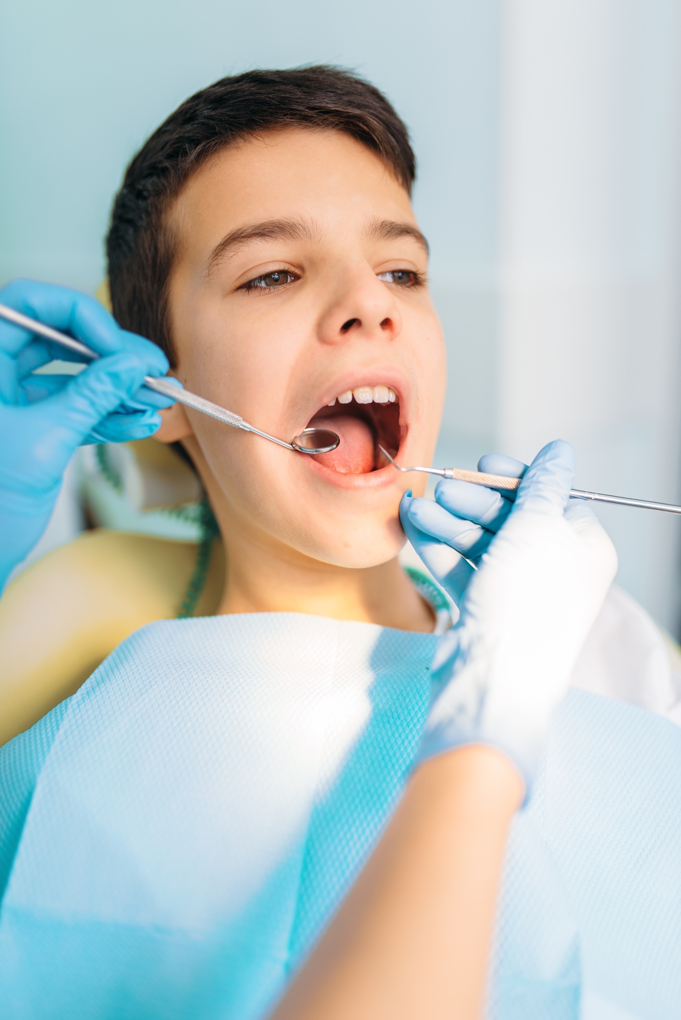 Little boy with open mouth in a dental cabinet